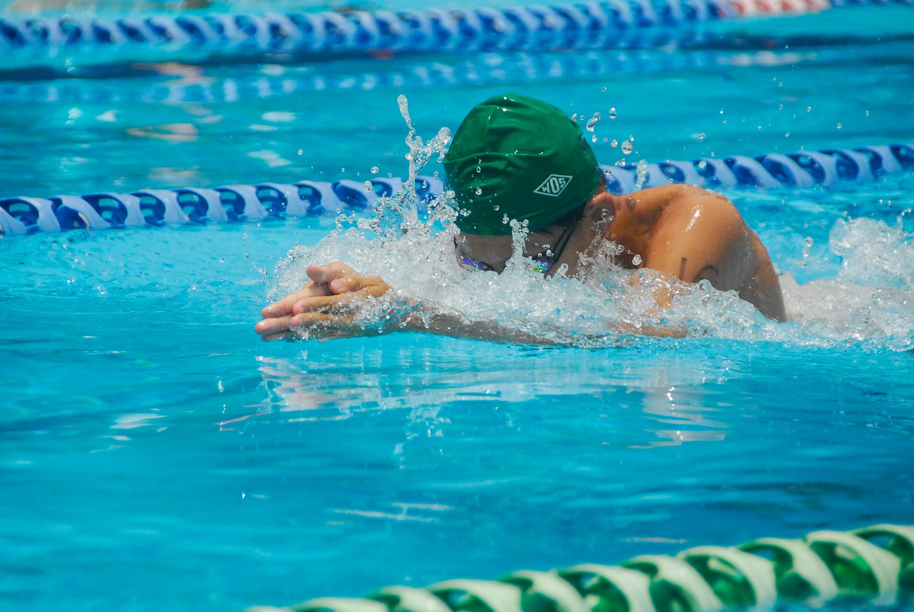 shallow focus photo of person swimming