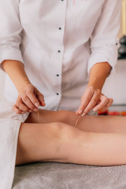 person putting needles to the knees