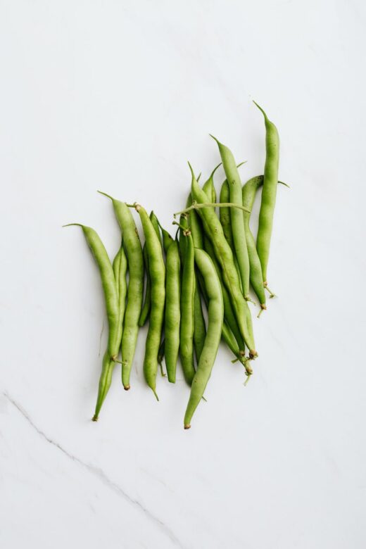 green peas on white surface