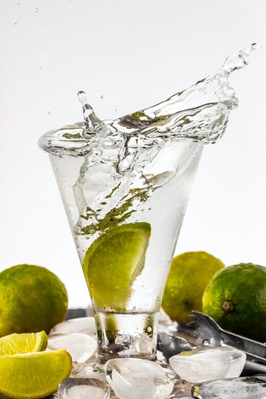 water filled glass cup with sliced lime