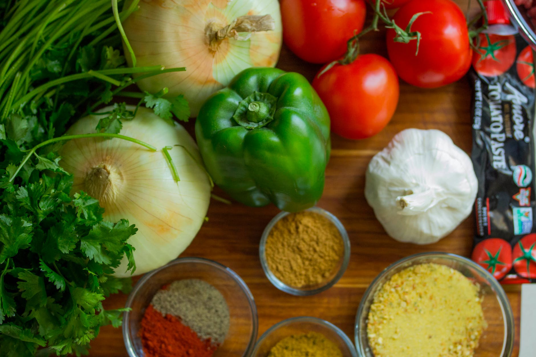 assorted vegetables and spices on wood surface