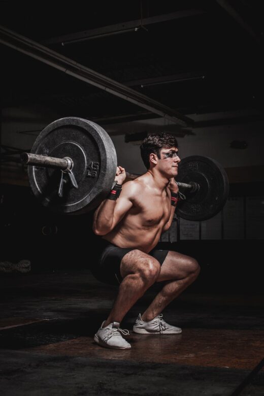 photo of man lifting barbell