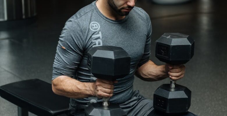 man sitting on flat bench