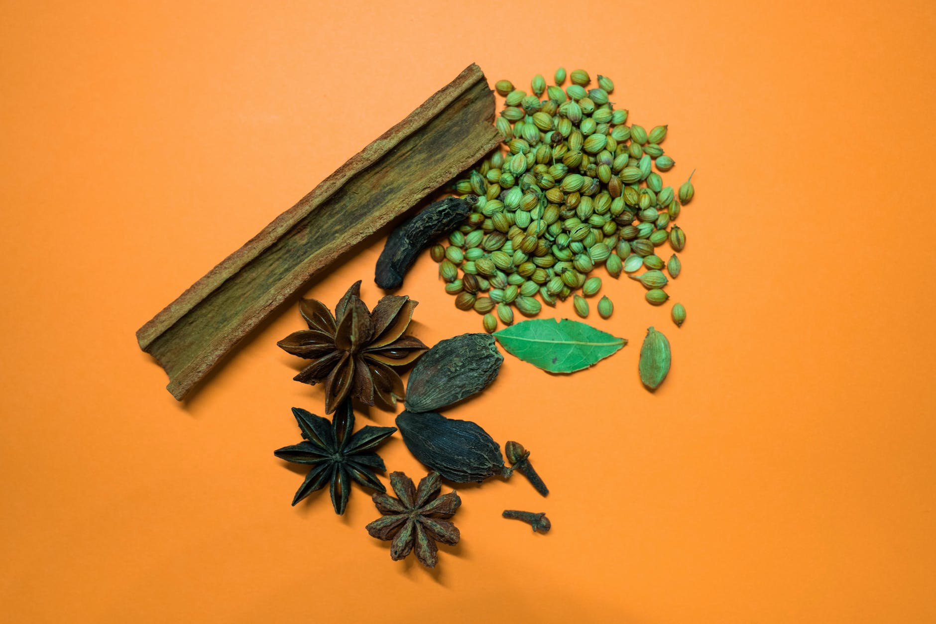 aromatic spices on an orange surface