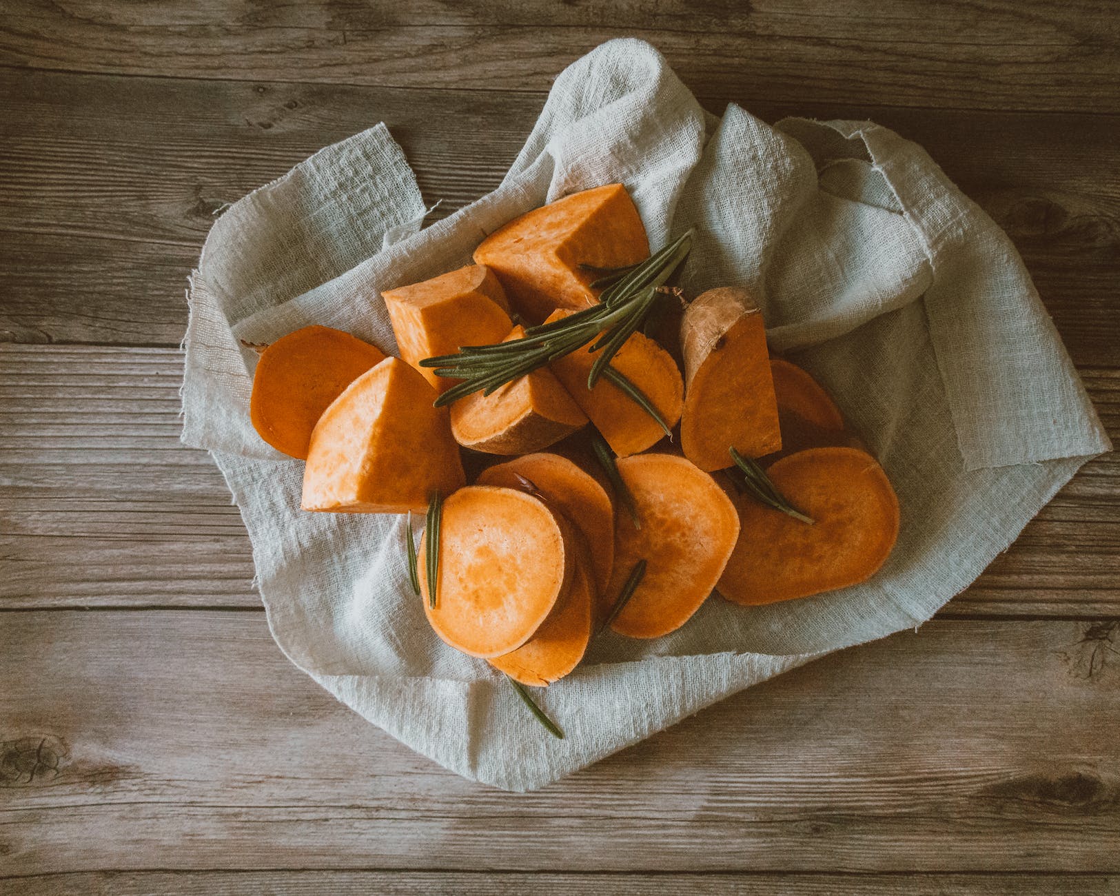 overhead shot of chopped sweet potatoes on a piece of cloth