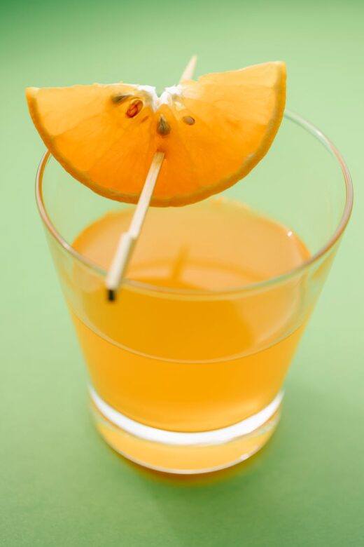 slice of orange decorating glass of drink