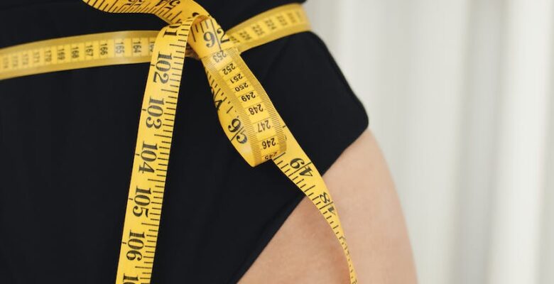 a measuring tape on a woman s waist
