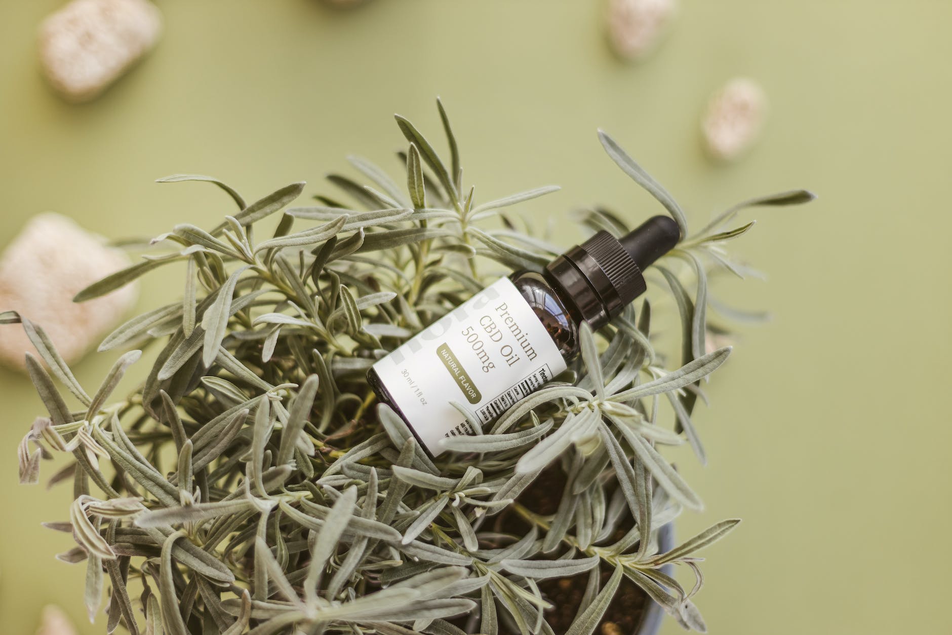 green and white dropper bottle in close up shot