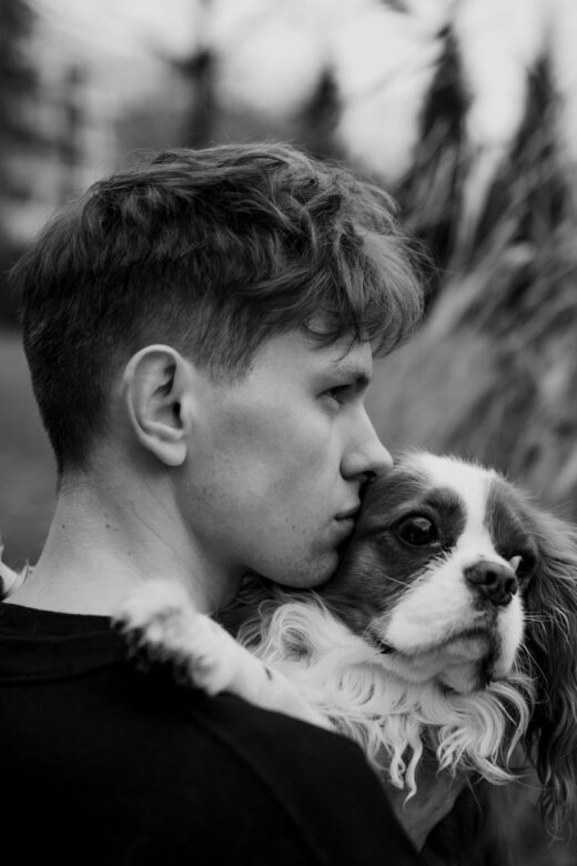 black and white portrait of man with cavalier king charles spaniel