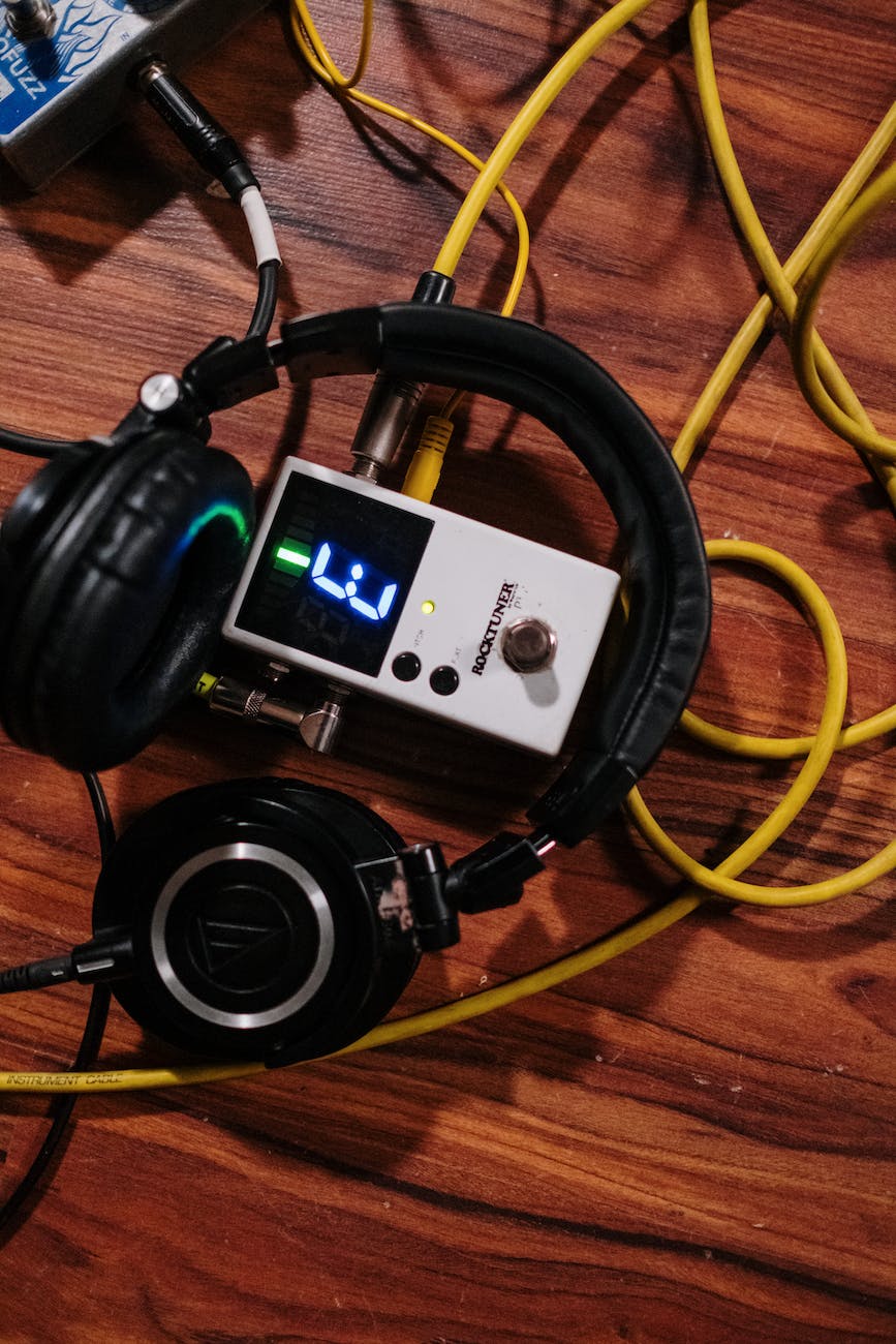 headphones with yellow cord on a wooden surface