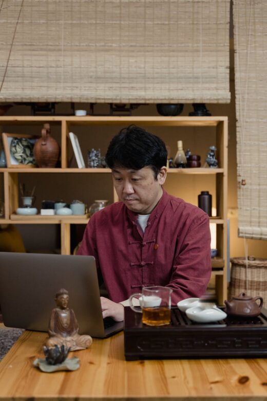 man remote working during tea ceremony