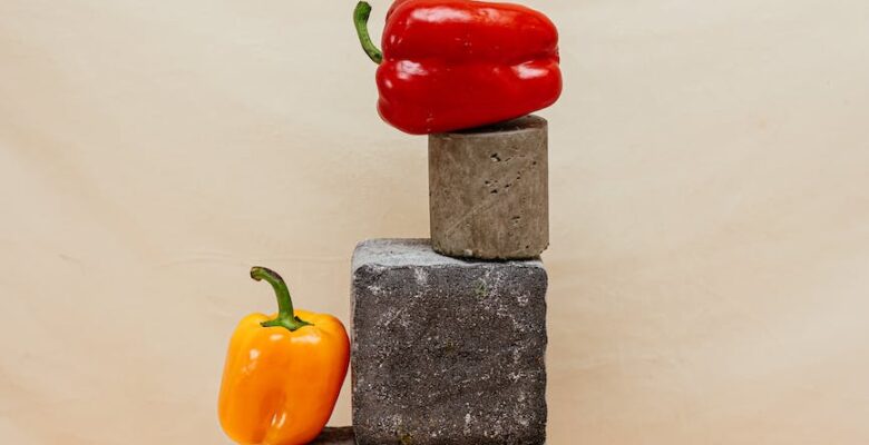 red bell pepper on the top of a concrete block