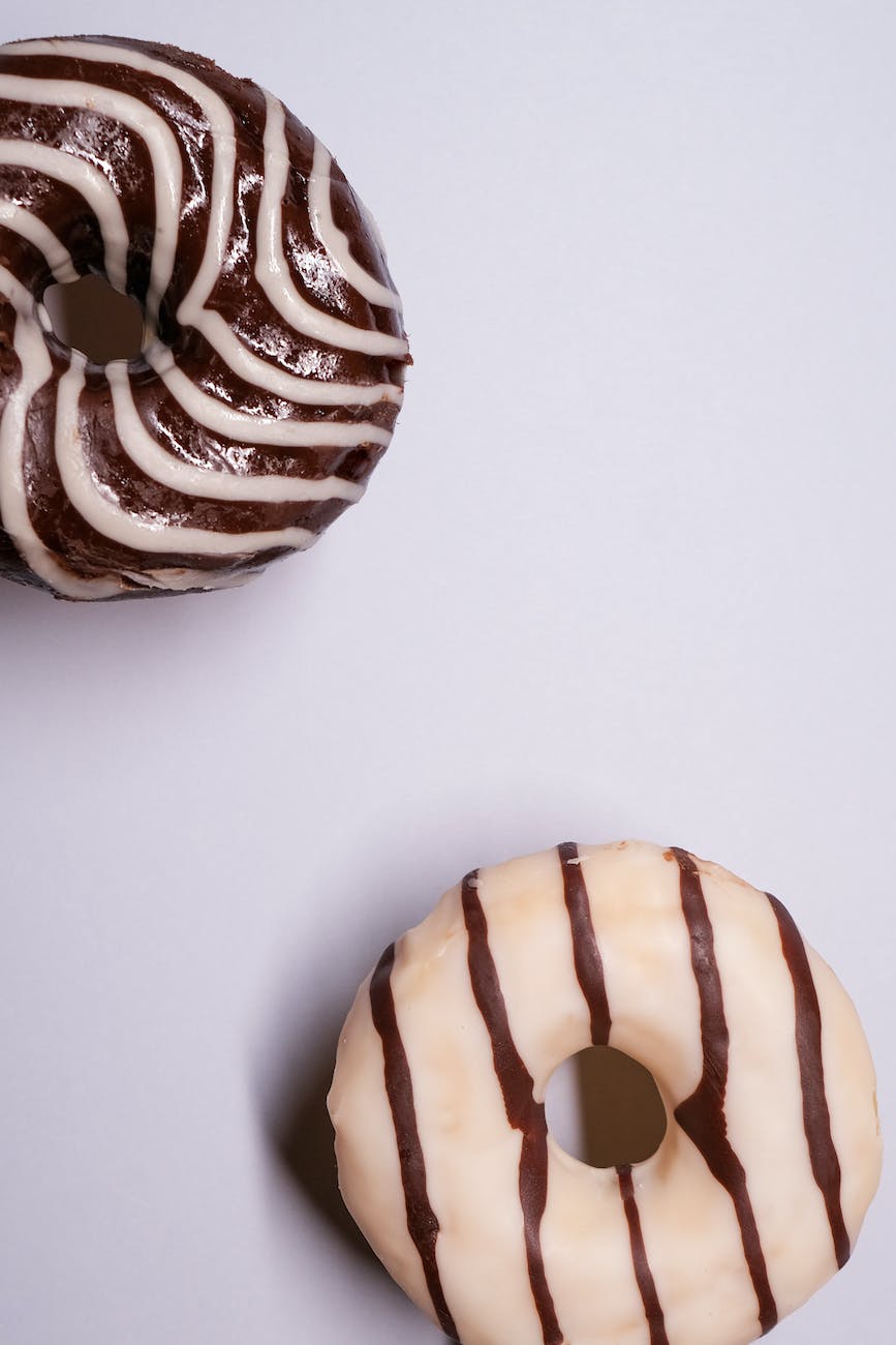 appetizing glazed donuts served on gray surface