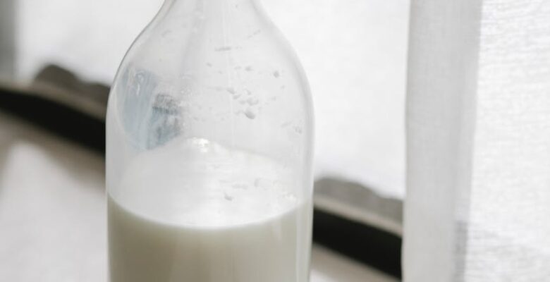 bottle of fresh milk on windowsill at home