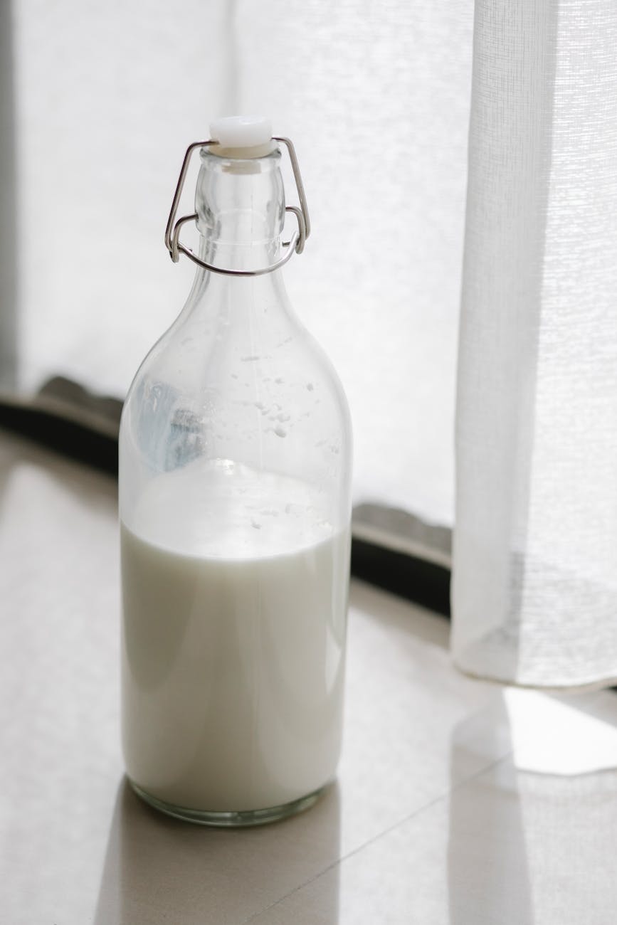 bottle of fresh milk on windowsill at home