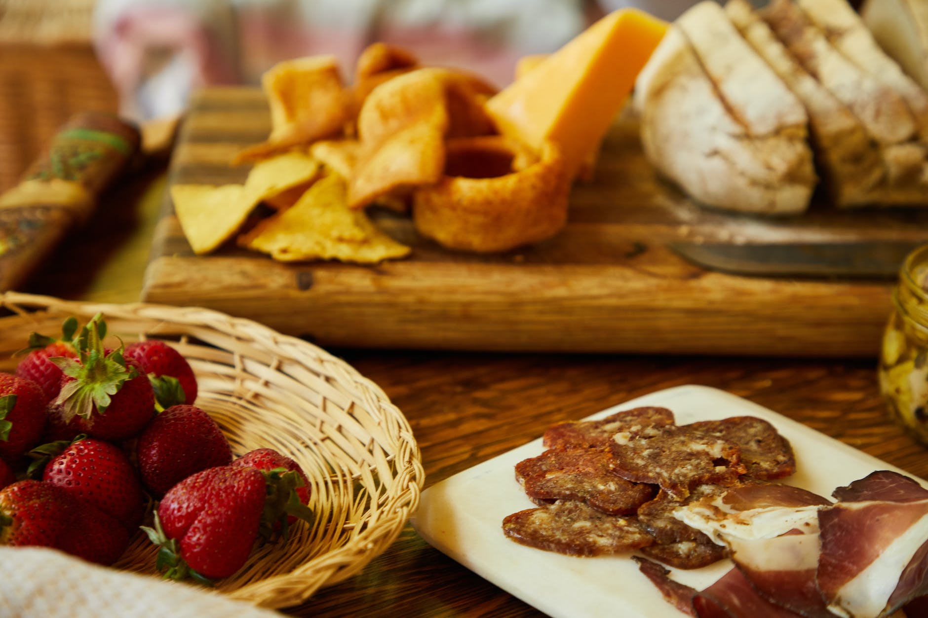 table with cold cuts strawberries and other snacks