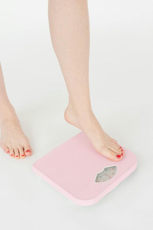 woman getting on scales in studio