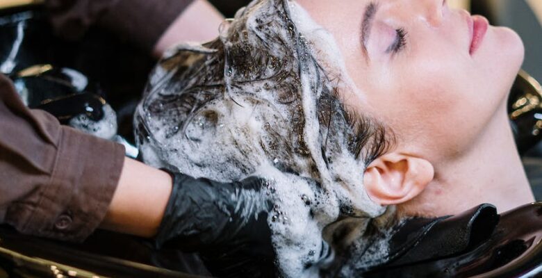 person washing woman s hair