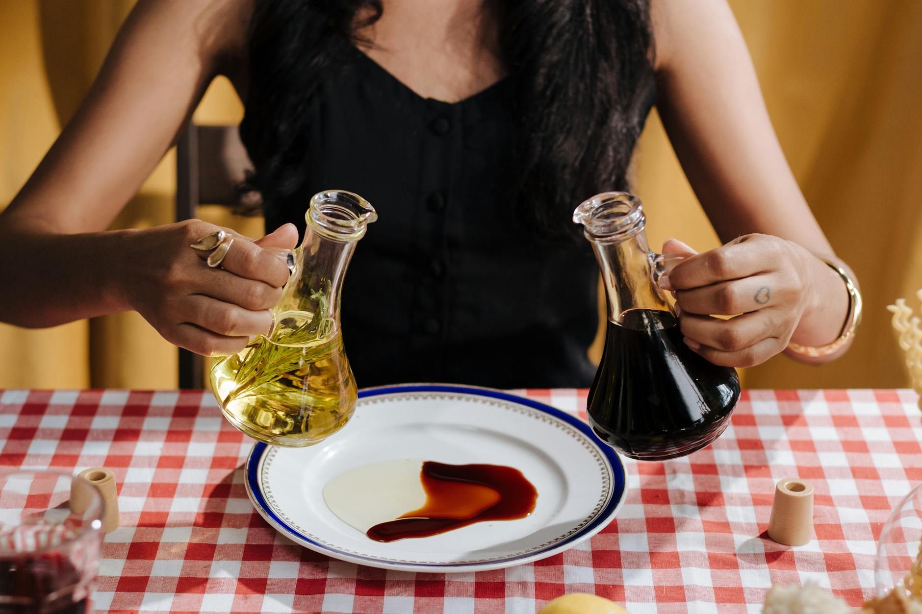 woman with olive oil and vinegar bottles in hands