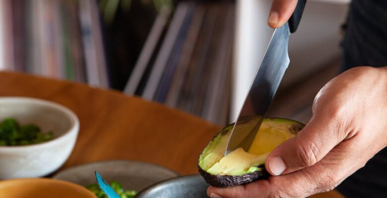 a person slicing avocado