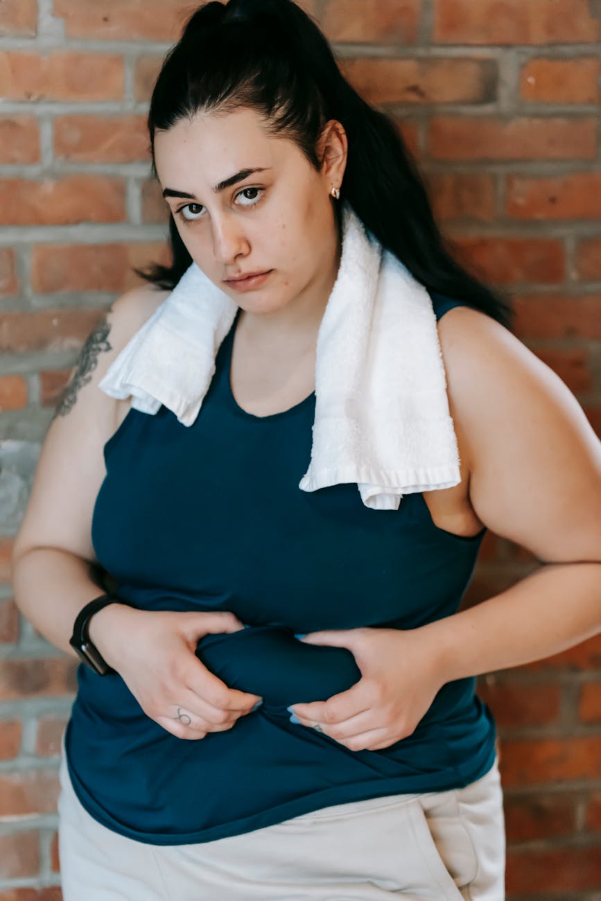 hopeless plus size woman demonstrating fold on stomach