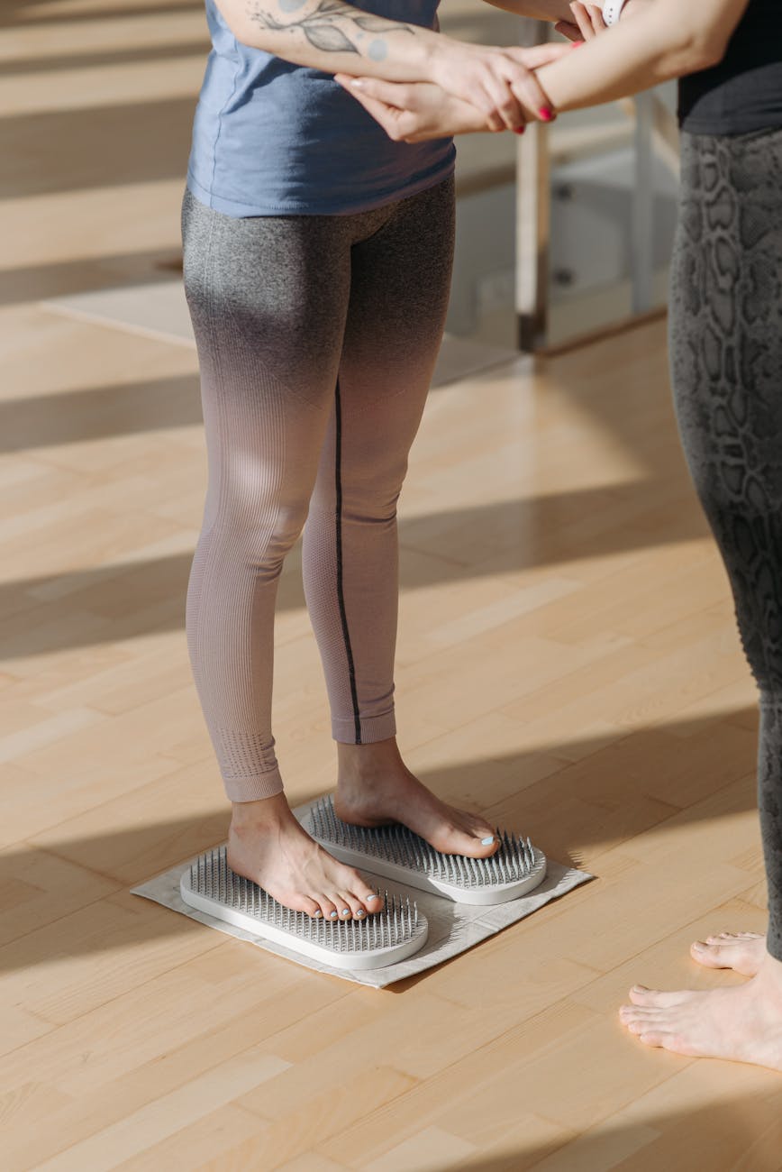 woman standing on an acupressure foot mat