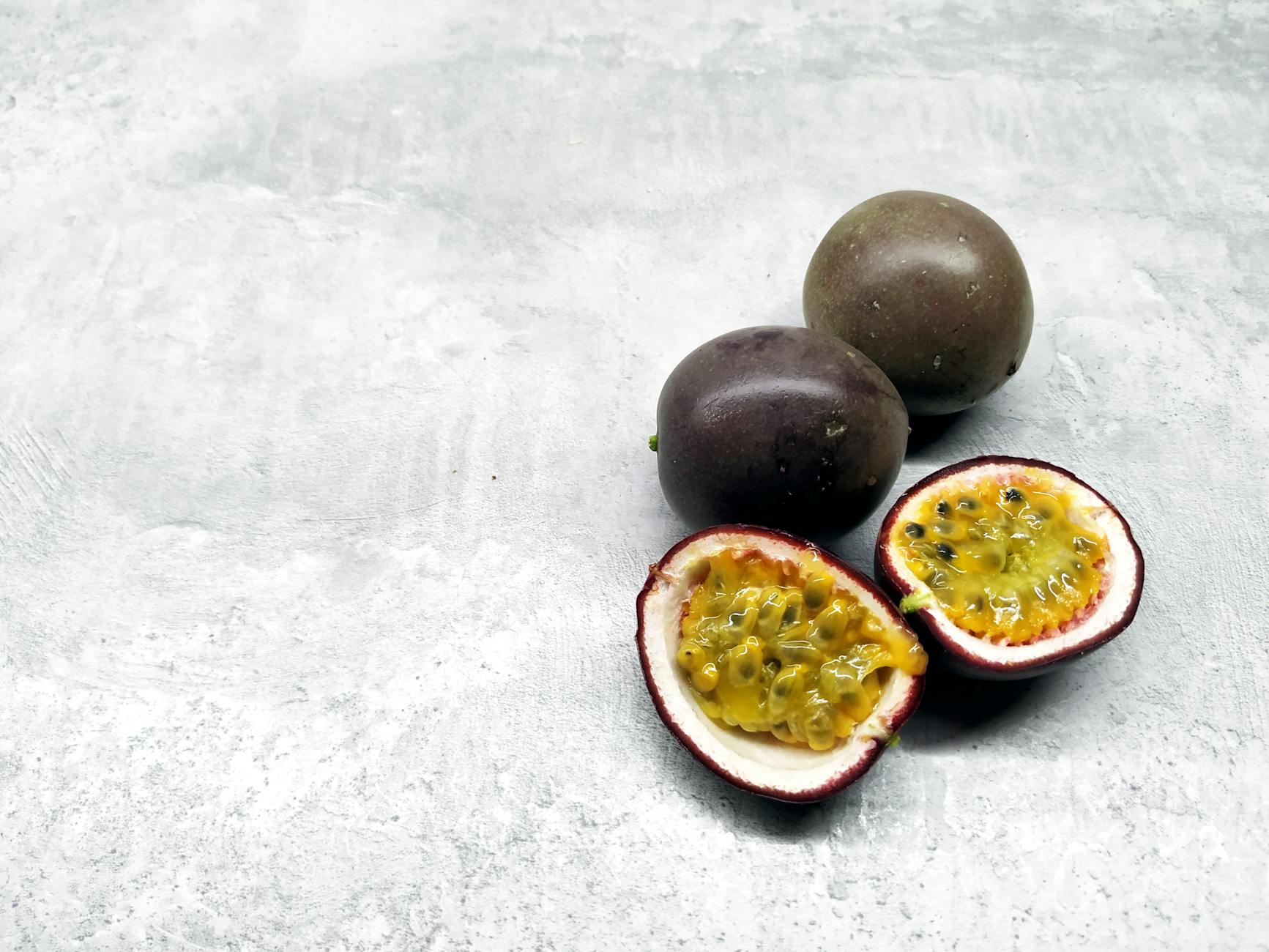 a sliced passion fruit on a flat surface
