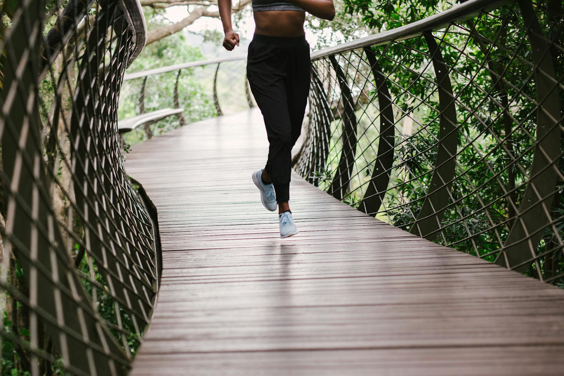 photo of person running on bridge