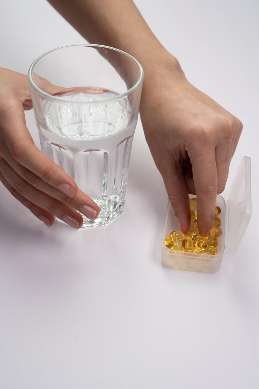 person holding clear drinking glass