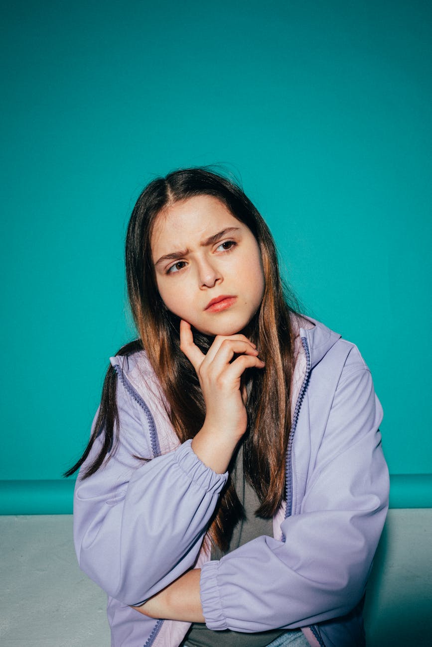 girl wearing a jacket thinking