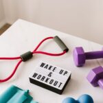 wake up and workout slogan on light box among sports equipment