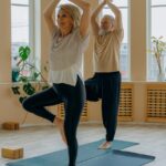 elderly couple standing on yoga mats